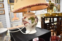 A modern Moorcroft pottery 'columbine' pattern table lamp, tube lined with flowers against a cream