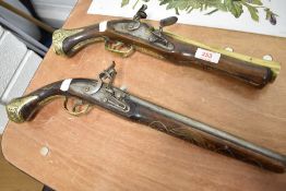 Two reproduction flint lock pistols.