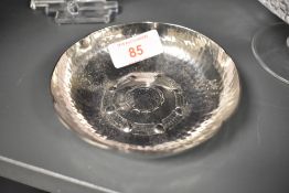 A Lakeland Rural Industries (LRI) Borrowdale, planished stainless steel pin dish, of stylised