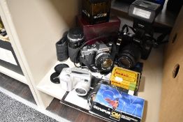 A selection of cameras,lenses and accessories including Olympus, canon and Nikon cameras.