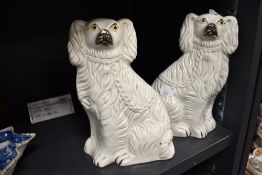 A pair of Victorian Staffordshire pottery spaniels, nicely moulded, with some wear to muzzles.