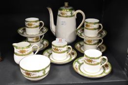 A Crown Straffordshire six-piece coffee set, decorated in gilt and green, comprising six cans, six