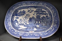 A 19th century transfer-printed blue and white Willow pattern ashette, marked 'Stone Ware U & H'