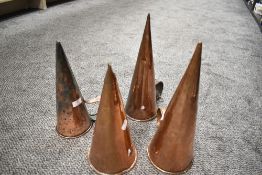 A group of four Victorian copper ale mullers, of typical conical form with applied loop handles.