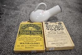 A vintage Swedish 'Kockums' white enamel bed pan and two boxes of vintage toilet paper.