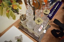 An early 20th century silver plated condiment rack with six bottles.