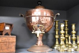 An early 20th century copper Samovar, with brass tap and brass and ebonised wood handles, the base