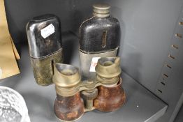Two early 20th century leather covered glass hip flasks, sold along with a pair of binoculars
