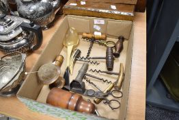 A selection of vintage cork screws, treen pin cushion, steel candle snuffer, boxwood bottle case