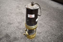 A vintage brass and steel miners lamp, number 393