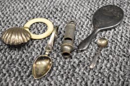 A white metal scallop shell-from rattle with teething ring, whiter metal baby feeding spoon, child's