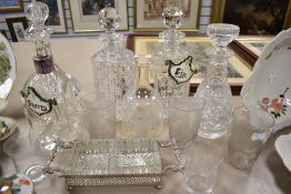 A variety of glass amongst which are decanters, early 20th century etched glasses and more.
