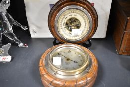 An early - mid 20th century oak framed Smiths clock sold with a barometer of similar form.