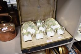 A boxed set of Royal Crown Derby coffee cans and saucers having gilt basket weave and floral pattern
