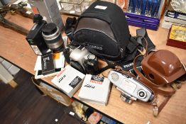 A collection of cameras and accessories including Pentax MZ-30 and Kodak Colorsnap 35.