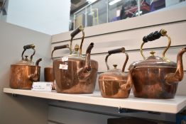 A group of five copper kettles, Victorian and later, various sizes.