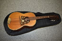 An early 20th Century guitar shaped mandolin , in later padded gig bag