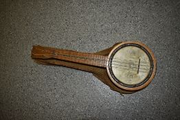 A traditional early 20th Century banjo ukulele , in canvas bag