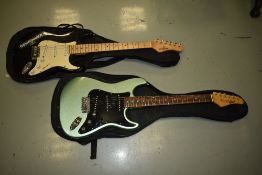 Two Stratocaster style electric guitars, Columbus and Behringer