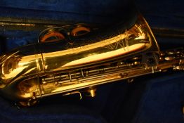 A brass saxophone, B & M Champion, in wooden case