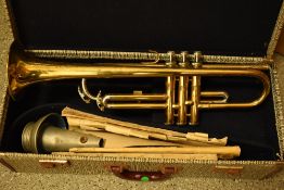 A vintage Selmer student brass trumpet, in semi hard case, bit of surface rust but valves ok,