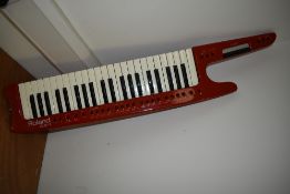 A rare Roland AX-1, Red Keytar Midi Controller, with soft gig bag