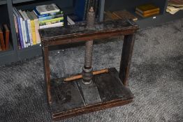 A vintage wooden book press.