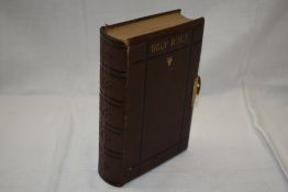 Holy Bible. A late Nineteenth century example, leather bound with brass clasp to fore-edge. (1)