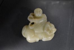 A Chinese sun jade Carving depicting tiger tamer.