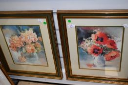 A pair of prints depicting still life floral scenes