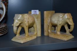 A pair of hand carved stone book ends in the form of elephants