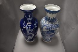 A large blue and white ware cherry blossom decorated vase and similar Chinese style vase .