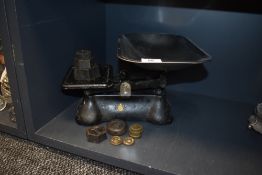 A set of vintage kitchen balance scales with weights