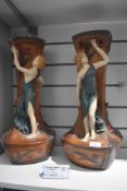 A pair of Figural vases having maidens to sides and floral detail.