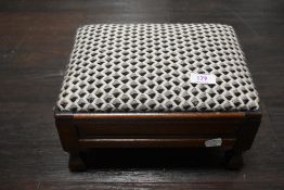A small wooden footstool