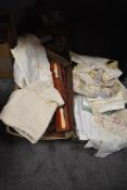 A selection of vintage textiles including table settings and embroidered silk