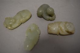 Four Chinese sun jade/natural stone carvings including people and dog.