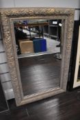 A gilt effect framed mirror