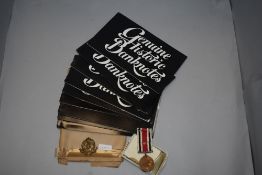 A selection of Genuine historic bank notes, a cap badge and medal