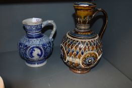 A Doulton Lambeth ewer and similar Mettlach styled jug