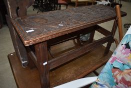 An Ethnic tribal art style side table having carved and pokerwork decoration, width approx. 92cm