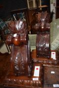 A pair of ornate hardwood wall sconces