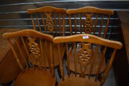 A set of four rubberwood type kitchen chairs