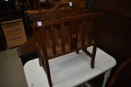 An Arts and Crafts oak canterbury magazine stand