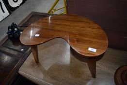 A vintage occasional table having kidney shaped top and triple splay legs