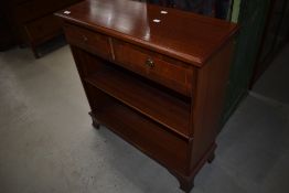 A reproduction Regency hall shelf, with two frieze drawer over bookshelves