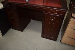 A reproduction pedestal desk