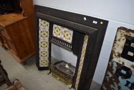 A reproduction cast and tiled fire surround (af)