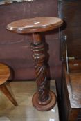 A mahogany jardiniere stand having carved column
