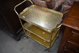 A vintage brass effect (probably aluminium) tea trolley